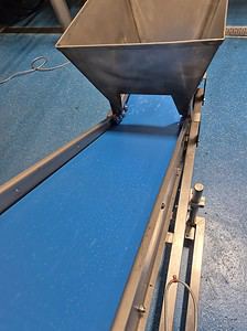 Conveyor belt for material handling and processing. Durable stainless steel construction for industr.
