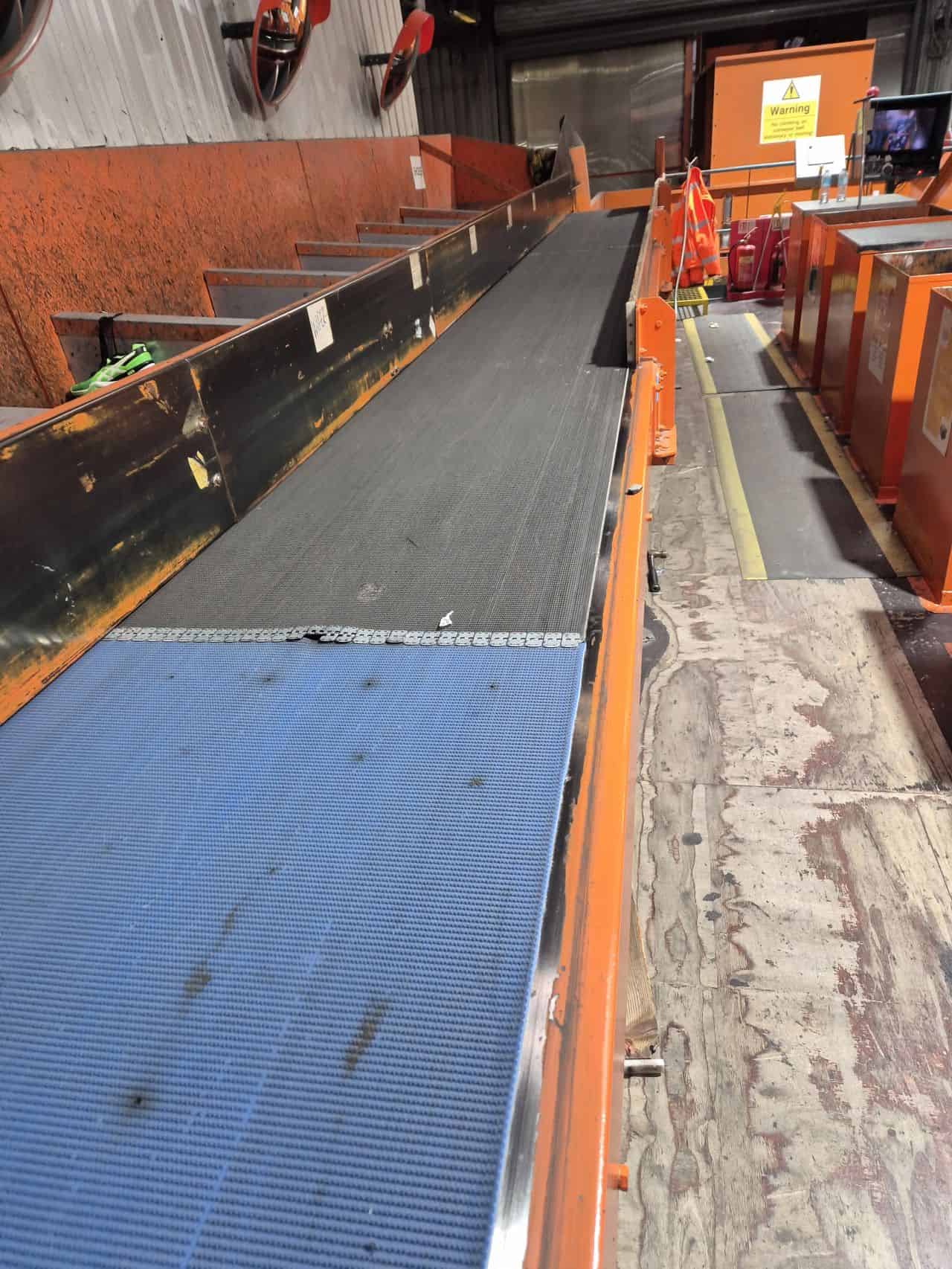 Heavy-duty conveyor belt used in industrial manufacturing processes.