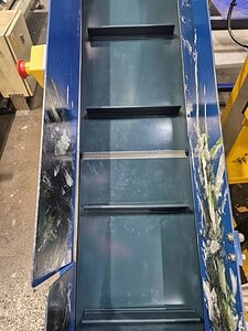 Industrial belting conveyor with multiple tiers for material handling.