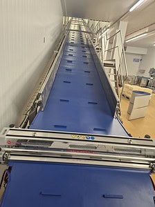 Conveyor belt system supplied by Premier Belting Services, ideal for manufacturing and logistics ope.