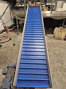 Heavy-duty blue conveyor belt for industrial material handling.